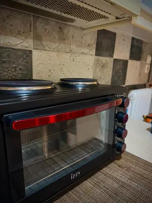 a black oven with two pans on top of it at Cozy home in Nea Smirni in Athens