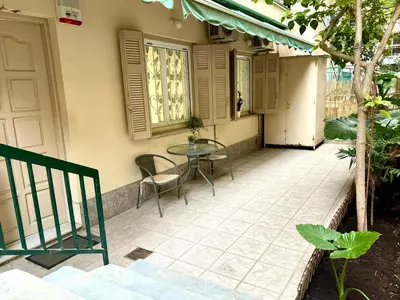 a patio with a table and chairs next to a building at Cozy home in Nea Smirni in Athens