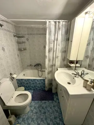 a bathroom with a toilet and a sink and a tub at Cozy home in Nea Smirni in Athens