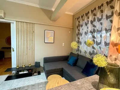 a living room with a couch and a table at Cozy home in Nea Smirni in Athens