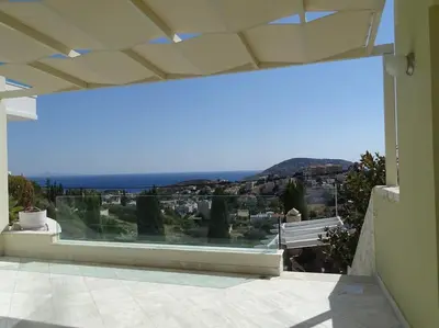 a large glass window of a house with a view at Luxurious Family friendly Villa Anavyssos in Anavissos