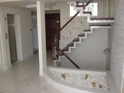 a room with a staircase with rocks on the floor at Luxurious Family friendly Villa Anavyssos in Anavissos