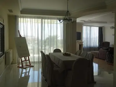 a room with a table and chairs and a living room at Luxurious Family friendly Villa Anavyssos in Anavissos