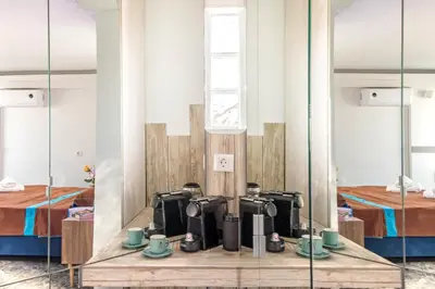 a room with two beds and a mirror at Parthenon crown penthouse in Athens