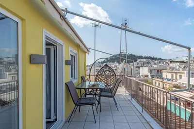 a balcony with a table and chairs and a view at Parthenon crown penthouse in Athens