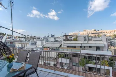 a balcony with a table and chairs and a city at Parthenon crown penthouse in Athens