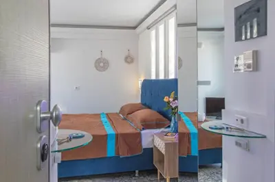 a bedroom with a bed and two glass tables at Parthenon crown penthouse in Athens