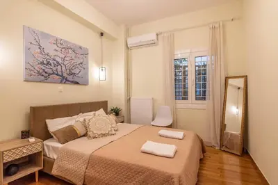 a small bedroom with a bed and a mirror at Nebiolo in Athens