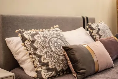 a bed with black and white pillows on it at Nebiolo in Athens