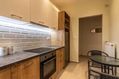 a kitchen with a counter and a table with chairs at Nebiolo in Athens
