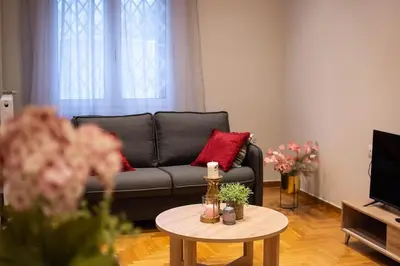 a living room with a couch and a table at Nebiolo in Athens