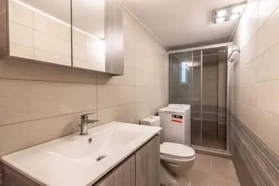 a bathroom with a white sink and a toilet at Nebiolo in Athens