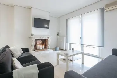a living room with a couch and a fireplace at Open -view Apartment, YGEIA Hospital in Athens