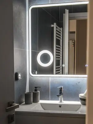 a bathroom with a sink and a mirror at Valeria's Sea View Apartment in Athens