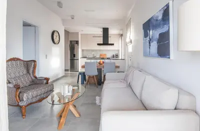 a living room with a couch and a table at Valeria's Sea View Apartment in Athens