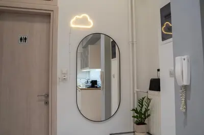 a bathroom with a mirror on the wall at E44 by SpitiSou in Athens
