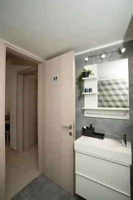 a bathroom with a sink and a mirror at E44 by SpitiSou in Athens
