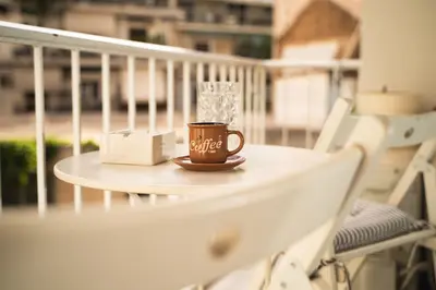 a coffee cup sitting on a table on a balcony at E44 by SpitiSou in Athens