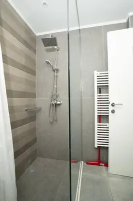 a shower with a glass door in a bathroom at E9 by SpitiSou in Athens