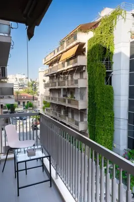 a balcony with a chair and a plant on a building at E9 by SpitiSou in Athens