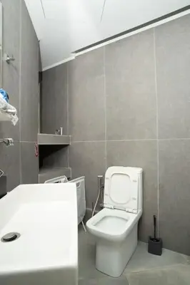 a bathroom with a white toilet and a sink at E9 by SpitiSou in Athens