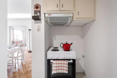 a kitchen with a stove with a tea kettle on it at Athenian Gate Residence to Plaka in Athens
