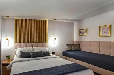 a hotel room with two beds and a window at CITYLUXE Suites & Rooms in Athens