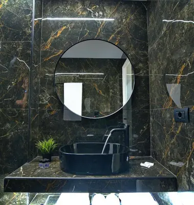 a bathroom with a sink and a mirror at CITYLUXE Suites & Rooms in Athens