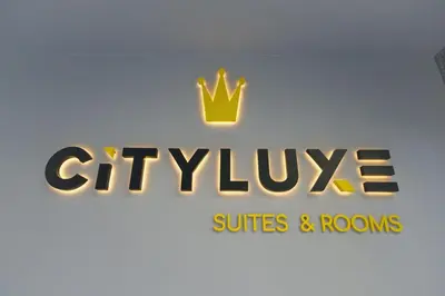 a sign for a cityville suites and rooms at CITYLUXE Suites & Rooms in Athens
