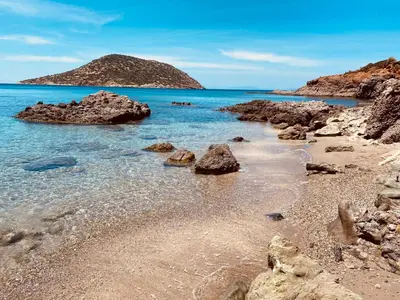 a beach with rocks and the ocean and a mountain at Villa Infinity View Athens Riviera in Anavissos