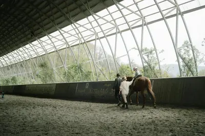 a group of people riding a horse in a building at Villa Infinity View Athens Riviera in Anavissos