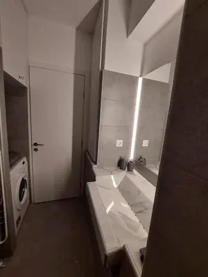 a bathroom with a sink and a mirror at Leo Athens Apartment Near Tram Station in Athens
