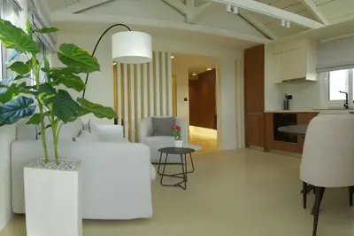 a living room with a white couch and a table at Luxury Penthouse w/ sea view in Athens