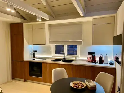 a kitchen with a table and a counter top at Luxury Penthouse w/ sea view in Athens