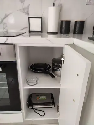 a kitchen cabinet with a stove top oven in it at Elegant & Modern Apartment near to Athens Riviera in Piraeus