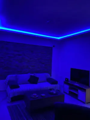 a living room with a couch and a blue light at Alexandra apartment in Athens
