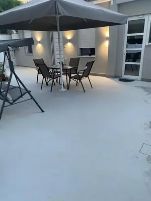 a patio with a table and chairs and an umbrella at Alexandra apartment in Athens