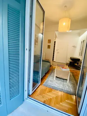 a view of a living room with a mirror at Antinoros Inn, Stylish apartment,3' to Metro in Athens
