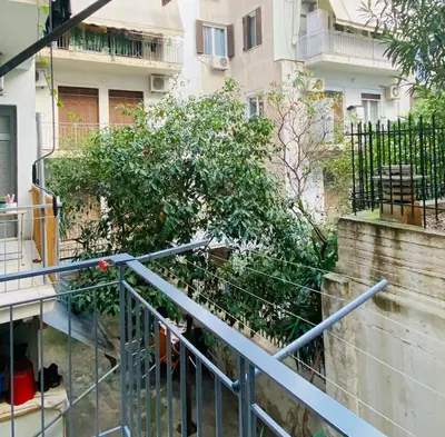 a staircase leading to a building with a plant at Antinoros Inn, Stylish apartment,3' to Metro in Athens