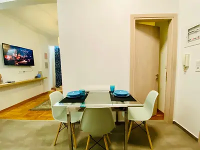 a dining room with a table and chairs at Antinoros Inn, Stylish apartment,3' to Metro in Athens