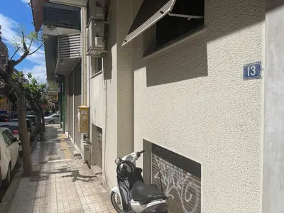 a scooter parked on the side of a building at Antinoros Inn, Stylish apartment,3' to Metro in Athens