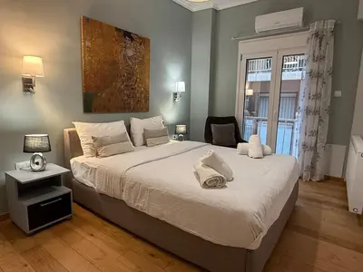 a bedroom with a large bed and a window at A Place 4U 42, 1 Bedroom & 1 Bathroom, near to Acropolis Athens in Athens