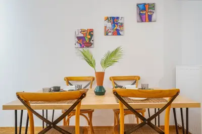 a dining room table with two chairs and a vase at A Place 4U 42, 1 Bedroom & 1 Bathroom, near to Acropolis Athens in Athens