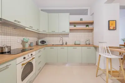 a white kitchen with white cabinets and a sink at A Place 4U 42, 1 Bedroom & 1 Bathroom, near to Acropolis Athens in Athens