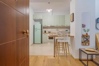 a kitchen with a blue refrigerator and a table at A Place 4U 42, 1 Bedroom & 1 Bathroom, near to Acropolis Athens in Athens