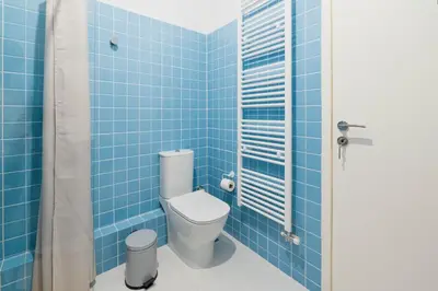 a blue tiled bathroom with a toilet and a shower at A Place 4U 42, 1 Bedroom & 1 Bathroom, near to Acropolis Athens in Athens