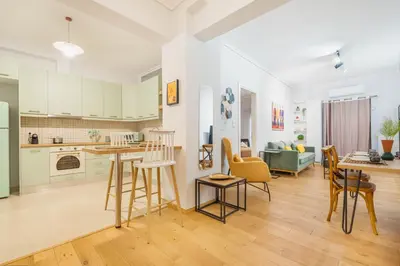 a kitchen and living room with a table and chairs at A Place 4U 42, 1 Bedroom & 1 Bathroom, near to Acropolis Athens in Athens