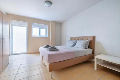a bedroom with a bed and a window at Serenity Villa by Comfortbnb in Saronida