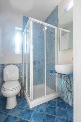 a bathroom with a shower and a toilet and a sink at Serenity Villa by Comfortbnb in Saronida