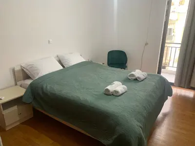 a bedroom with a bed with two towels on it at Calma apartment in Athens